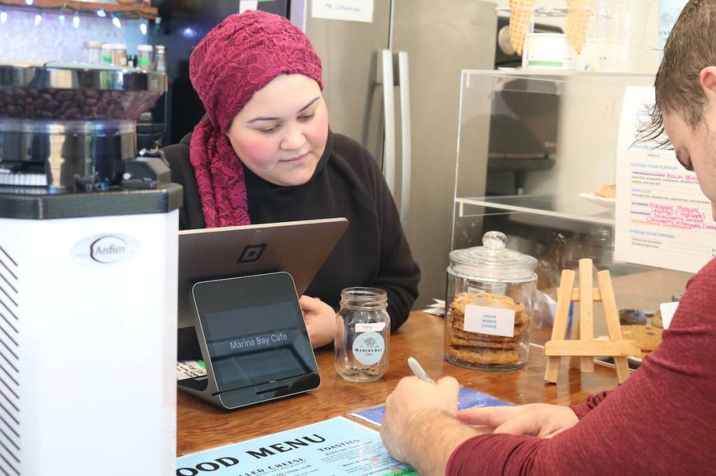 A Marina Bay Cafe customer writes down their order for Maria Tanjaoui. (Ben Fenlon/Victoria News)